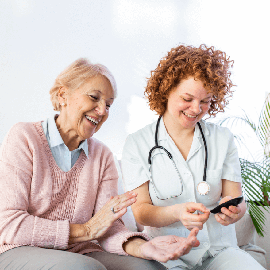 Home healthcare worker chats with older woman.