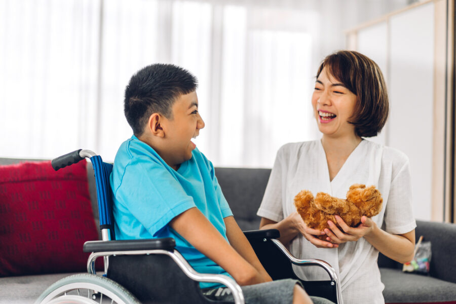 Pediatric home care giver works with child in wheelchair
