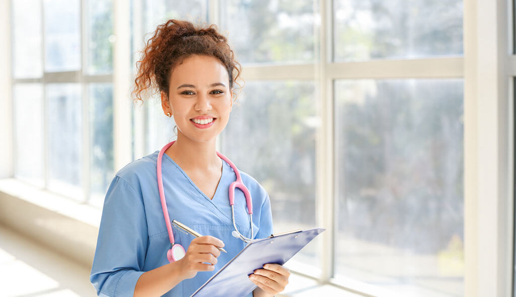Home healthcare worker consults medical chart.